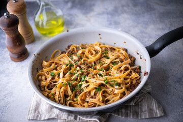 fettuccine ragu in frying pan
