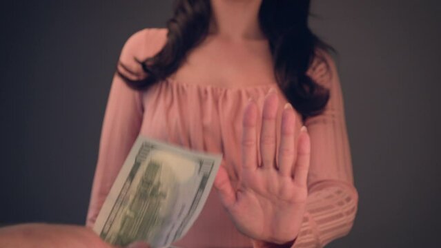Woman reject  the One hundred Dollars banknote in nominal 100 USD. Currency rate and exchange concept. Selective focus