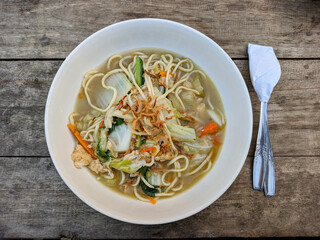 Delicious warm boiled noodles served with chunks of chicken, egg and vegetables. good to eat in...