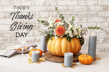 Greeting card for Happy Thanksgiving Day with beautifully served table with autumn composition and aroma candles