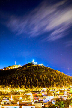 hill with lighthouse on top with houses and dark blue sky in zacatecas 