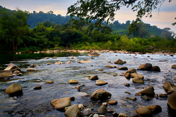 green river with a lot of rocks and jungle in the background with cloudy sky in filobobos river in martinez de la torre veracruz 