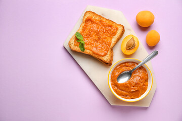 Board of tasty sandwich with sweet apricot jam on pink background