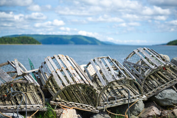 Old lobster traps lined up on the shore near Baddeck, Nova Scotia Canada.