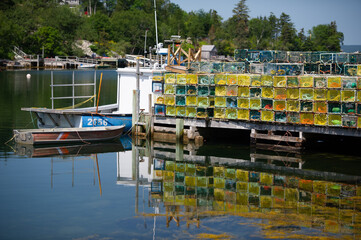 Lobster traps lined up on the wooden dock near Peggy's Cove, Nova Scotia Canada. - Powered by Adobe