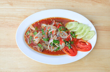 Shrimp spicy salad in dish on wood table background.