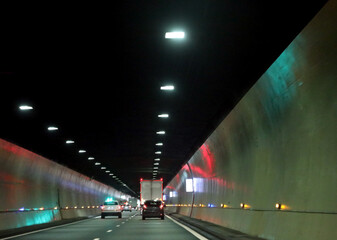 motorway tunnel to reach the places on the other side of the mountain with cars and LED lights