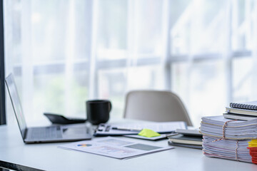 business office with documents and laptop on desk