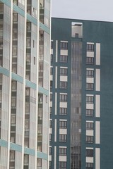 Full-color vertical photo. The geometric composition is made up of sections of the facades of city buildings.