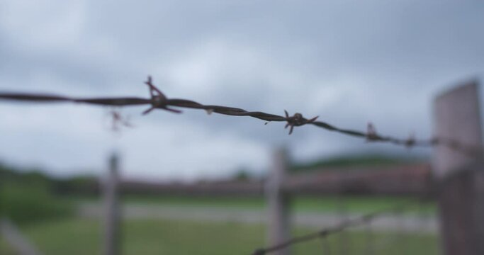 Barbed wire fence as storm rolls onto farm