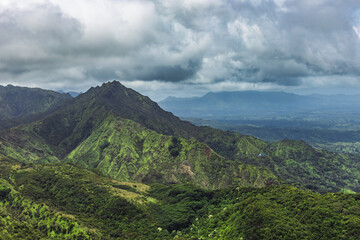 Naklejka premium Helicopter touring the mountains of the Gardern Isle - Kauai, Hawaii on an overcast day