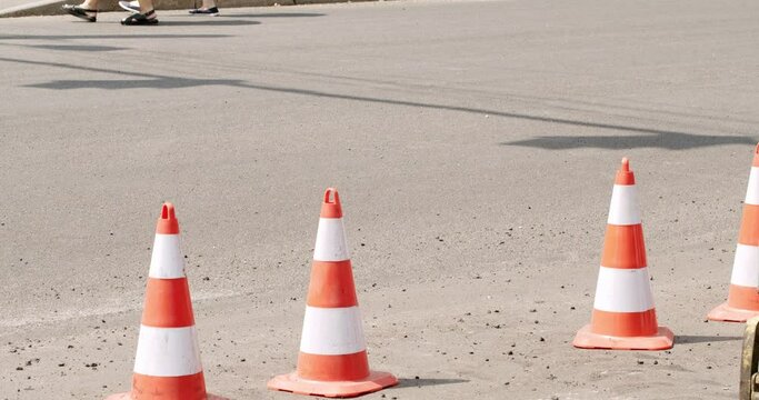 Roadworks signs on a street. Roadworks sign on a road. Repair work on the road. Workers laid new asphalt. work cone static closeup. traffic cones. Road maintenance work cone static closeup.