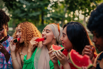 Girls eating watermelon outdoors