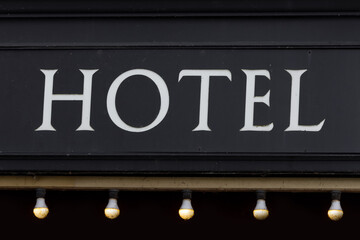 Obraz premium Hotel sign on old black wall