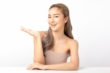 Happy beautiful asian woman looking to camera and showing empty copy space on the open hand. Asian girl beauty face skincare and health wellness, Facial treatment, Isolated on white background.