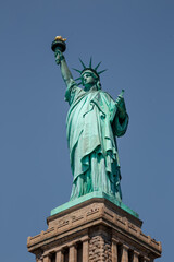 Fototapeta premium Statue of Liberty on the background of sky, New York City. The Statue of Liberty over the Scene of cityscape river side which location is lower manhattan. Architecture and building with tourist