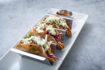 A view of three hard tacos.