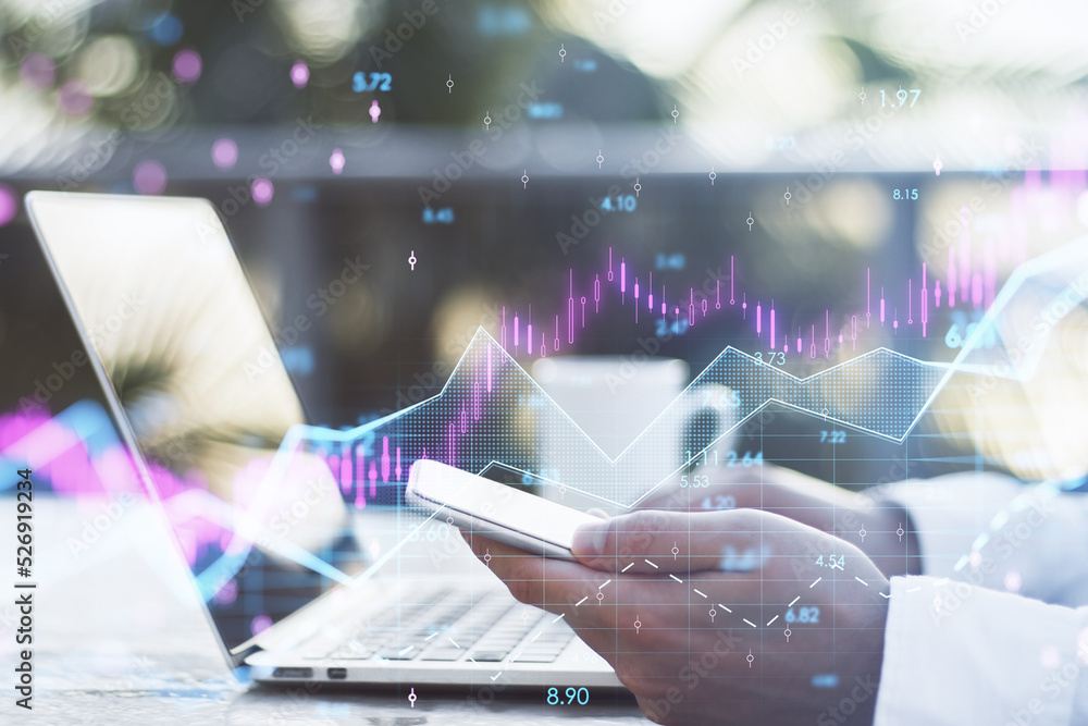 Poster hands using laptop and smartphone with abstract glowing candlestick forex chart with index and grid on blurry desktop background with coffee cup. Invest, trade, finance ans stock market concept. 