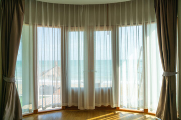 Fototapeta na wymiar curtain and glass window with sea beach view outside