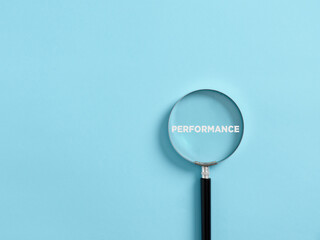 Magnifier focuses on the word performance. Analyzing or reviewing business job or employee...