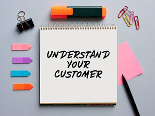 The message understand your customer written on a notebook on office desktop. Customer care in business