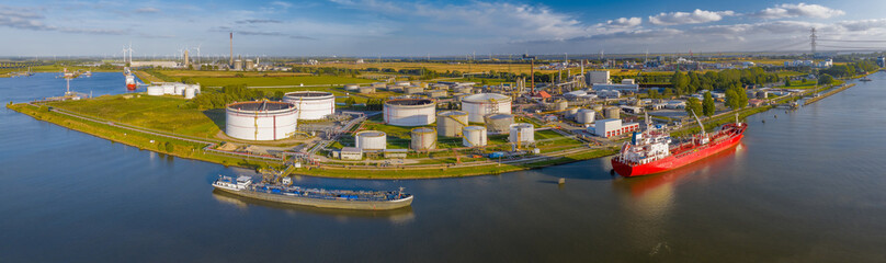 Aerial view of oil tankers moored at an oil storage silo terminal of chemical plant. Aerial view of...