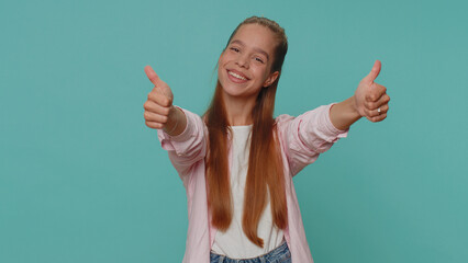 Like. Lovely pretty teenager girl raises thumbs up agrees with something or gives positive reply recommends advertisement likes good. Young stylish child kid isolated alone on blue studio background