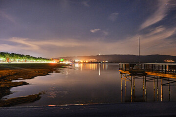 Obraz premium beautiful sunset over the lake iznik, Long exposure photo of lake iznik at night, wooden made pier and reflection on water pond.