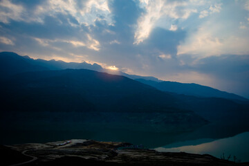 Fototapeta na wymiar Sunrise view of Tehri mountains. Scenery sunrise over Tehri Lake, Uttarakhand. Tehri Dam, the tallest dam in India and Tehri dam is Asia's largest man-made lake.