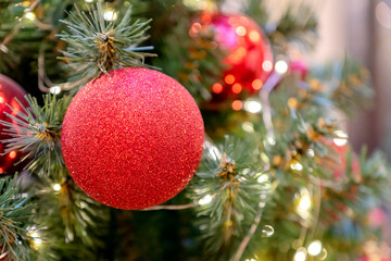 Christmas and New Year holidays background. Christmas tree decorated with baubles and garlands. Glittering and sparkling. Celebration concept
