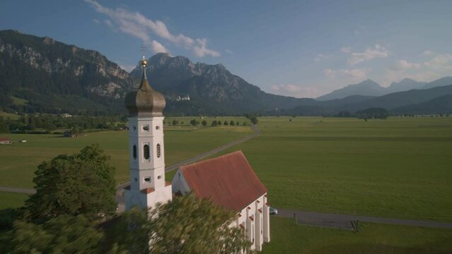 FPV drone shot passing the St. Coloman chapel in Schwangau, Germany - POV aerial