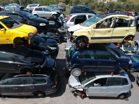 Cars in junkyard, pile for recycling.