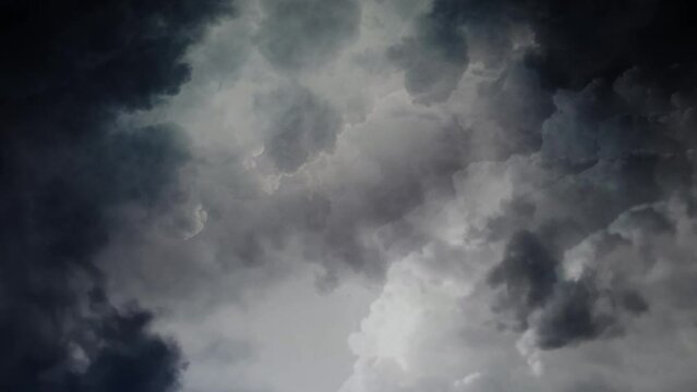 4k view of thunderstorm in moving clouds in dark sky.