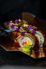 Obraz na płótnie Canvas chef decorating sushi rolls