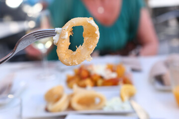 squid rings, lemon juice and potato with garlic sauce aioli and tomato ketchup on square plate © ulianna19970