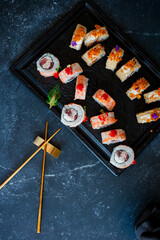 Obraz na płótnie Canvas Sushi roll on black board