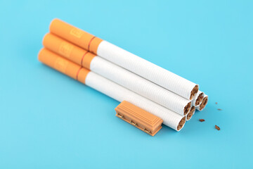 Cigarettes and a coffin on a blue background
