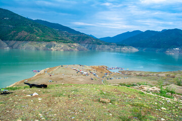 Tehri lake surrounded by mountains in Uttarakhand, india, Tehri Lake is an artificial dam reservoir. Tehri Dam, the tallest dam in India and Tehri dam is Asia's largest man-made lake.