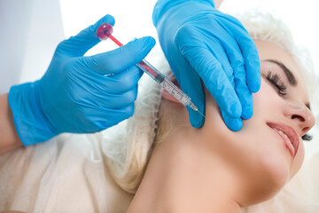 Cosmetic Treatment. Hands of Beautician During Female Facial Skin Lifting Injection At Woman's Face While Receiving Beauty Procedure in Beauty Salon