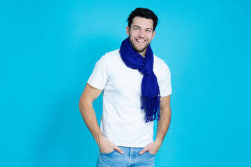 Youth Lifestyle Ideas. Caucasian Handsome Man Posing in White Shirt And Blue Scarf While Smiling And Looking Straight to Camera Over Blue