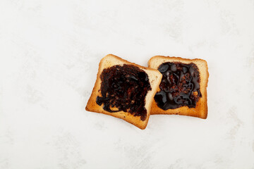 Two Hot toasts for breakfast, top view. Roasted Aussie savory toasts with vegemite spread. Vegemite is a very popular yeast based spread in Australia