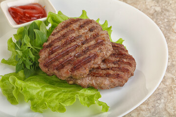 Grilled beef burger cutlet with sauce