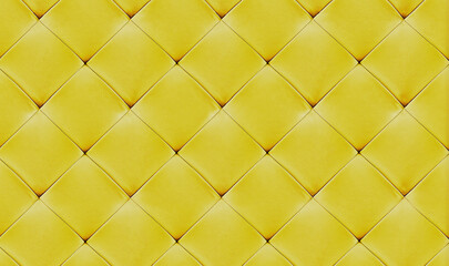 Fototapeta na wymiar Yellow natual leather background for the wall in the room. Interior design, headboards made of artificial leather, leatherette ,furniture upholstery. Classic checkered pattern for furniture, headboard