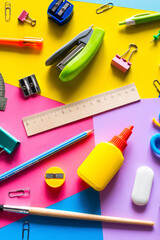 various accessories for study on a multi-colored background. back to school concept