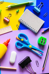 various accessories for study on a multi-colored background. back to school concept