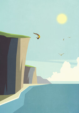 Woman diving off cliff into idyllic summer ocean
