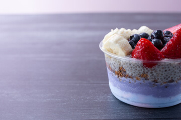 A view of a layered acai bowl, on the right side of the frame.