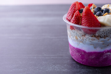 A view of a layered pitaya bowl, on the right side of the frame.