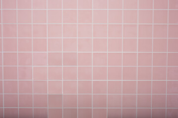 A view of a urban rustic pink tile wall facade as a background.