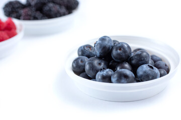 A closeup view of a bowl of blueberries.